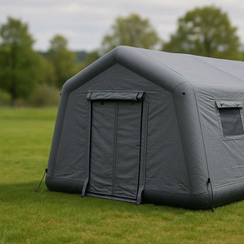 Inflatable tent on grass with trees in the background